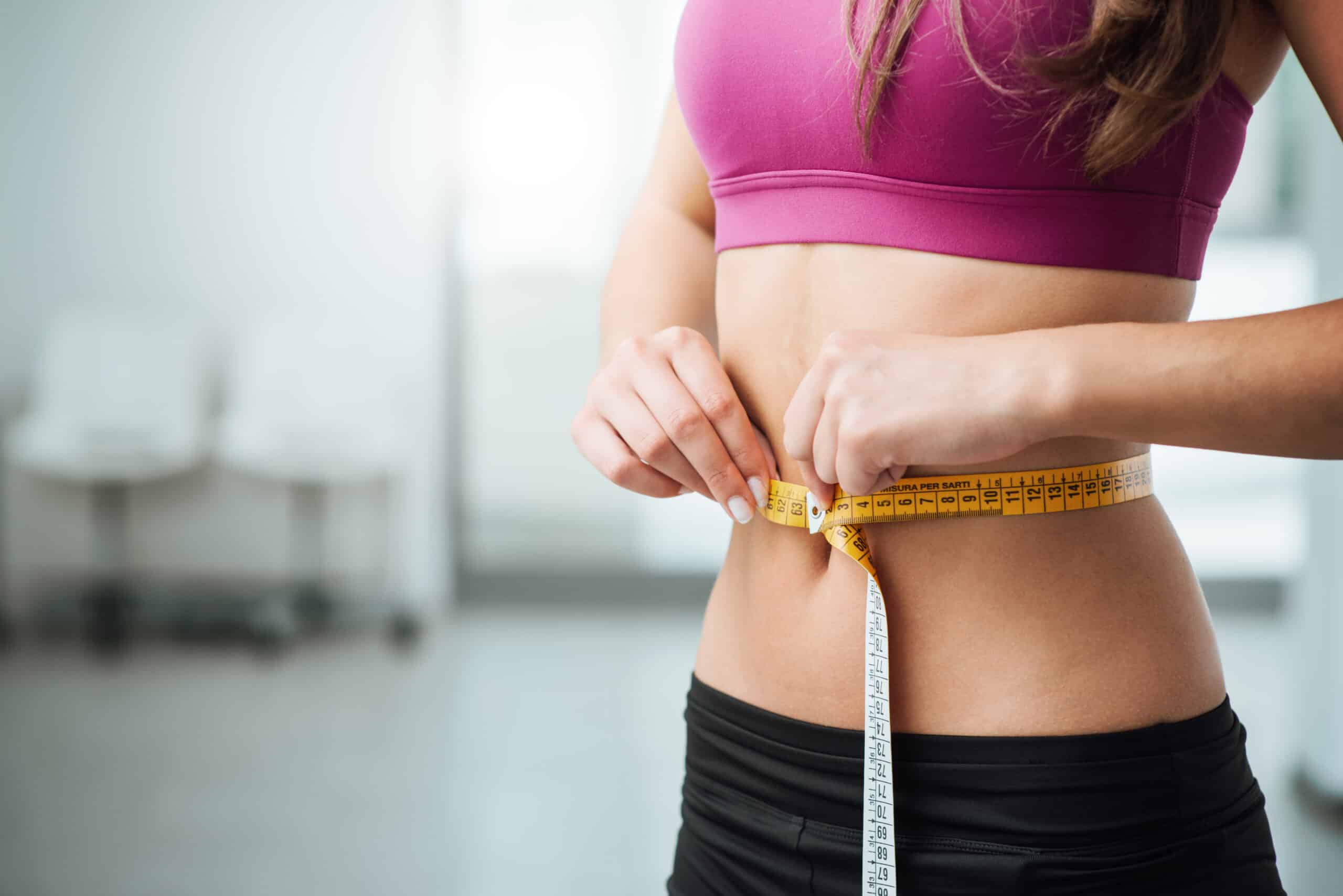 A woman with a tape measure around her waist