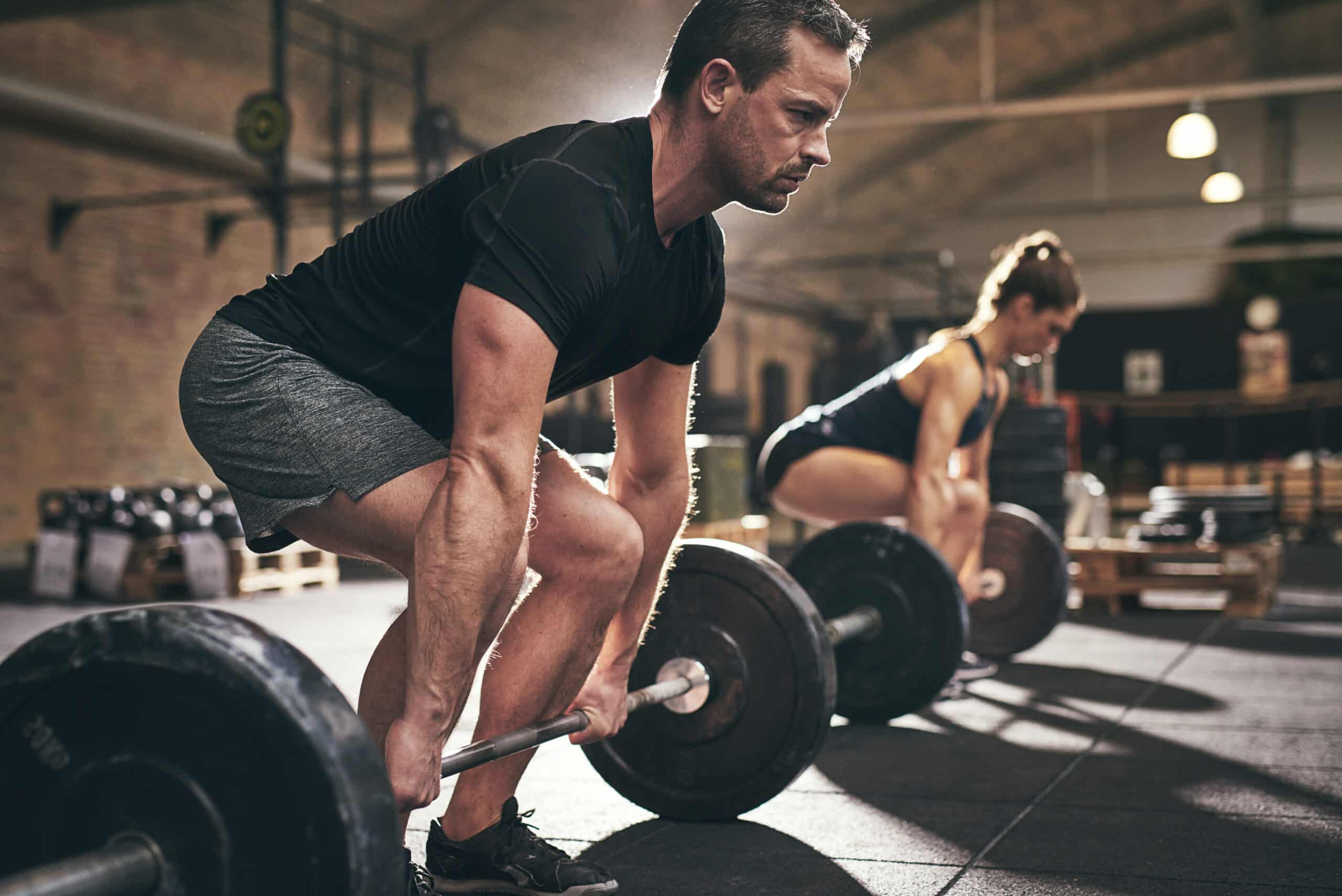 A man and woman lifting weights